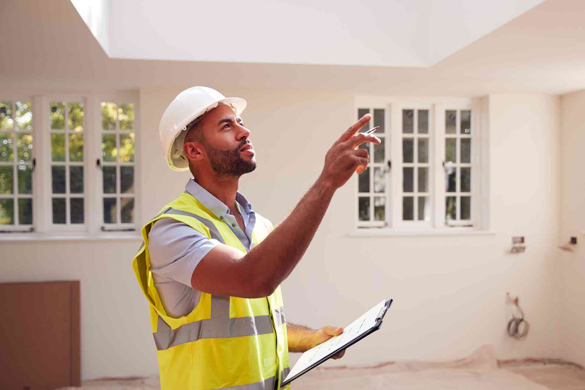 Third Party Wall Surveyors Swindon reviewing plans between two parties during a dispute